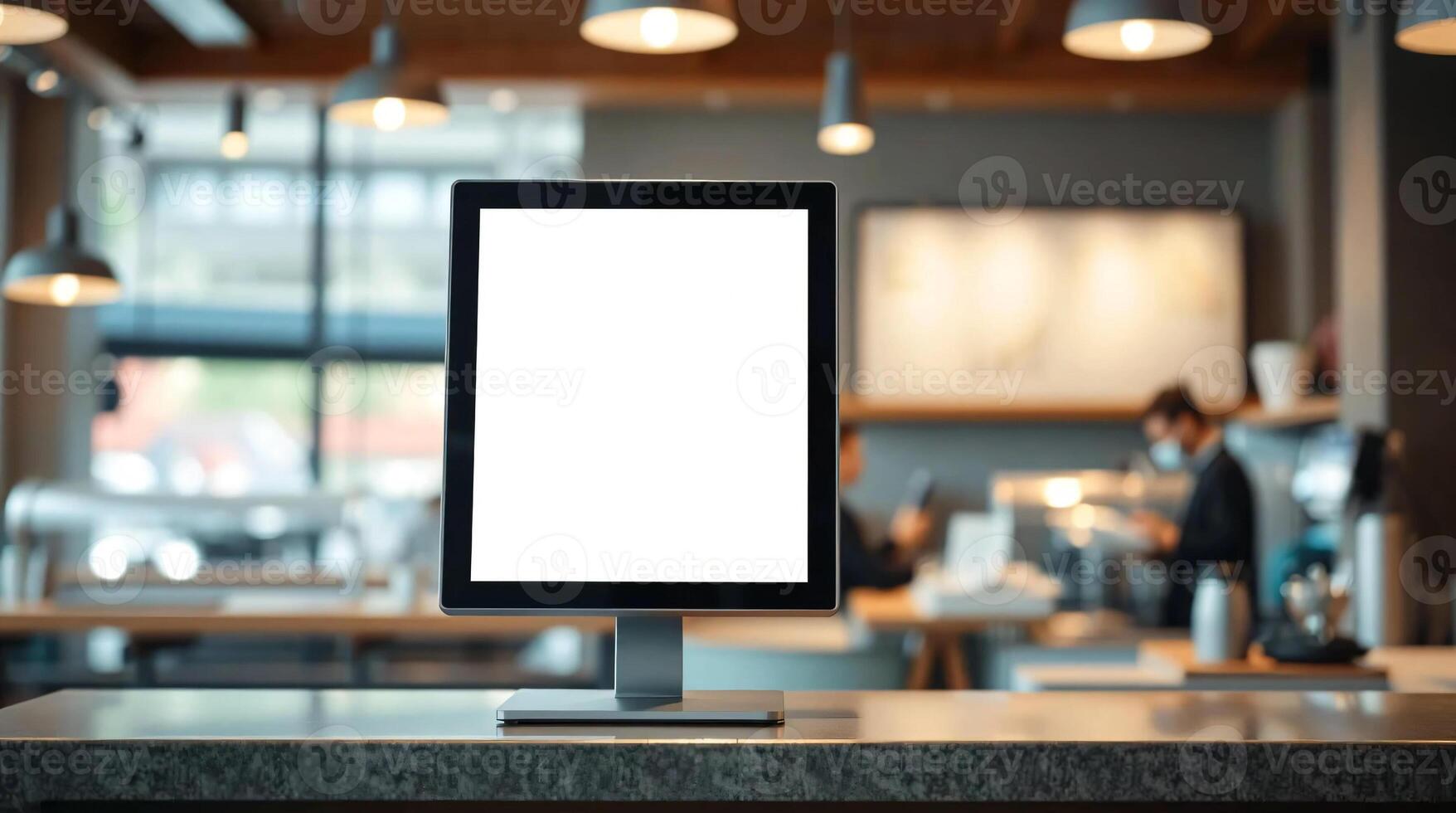 A blank screen on a desk in a coffee shop photo