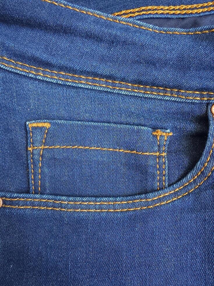 close up pocket and small pocket in faded blue jeans, photo