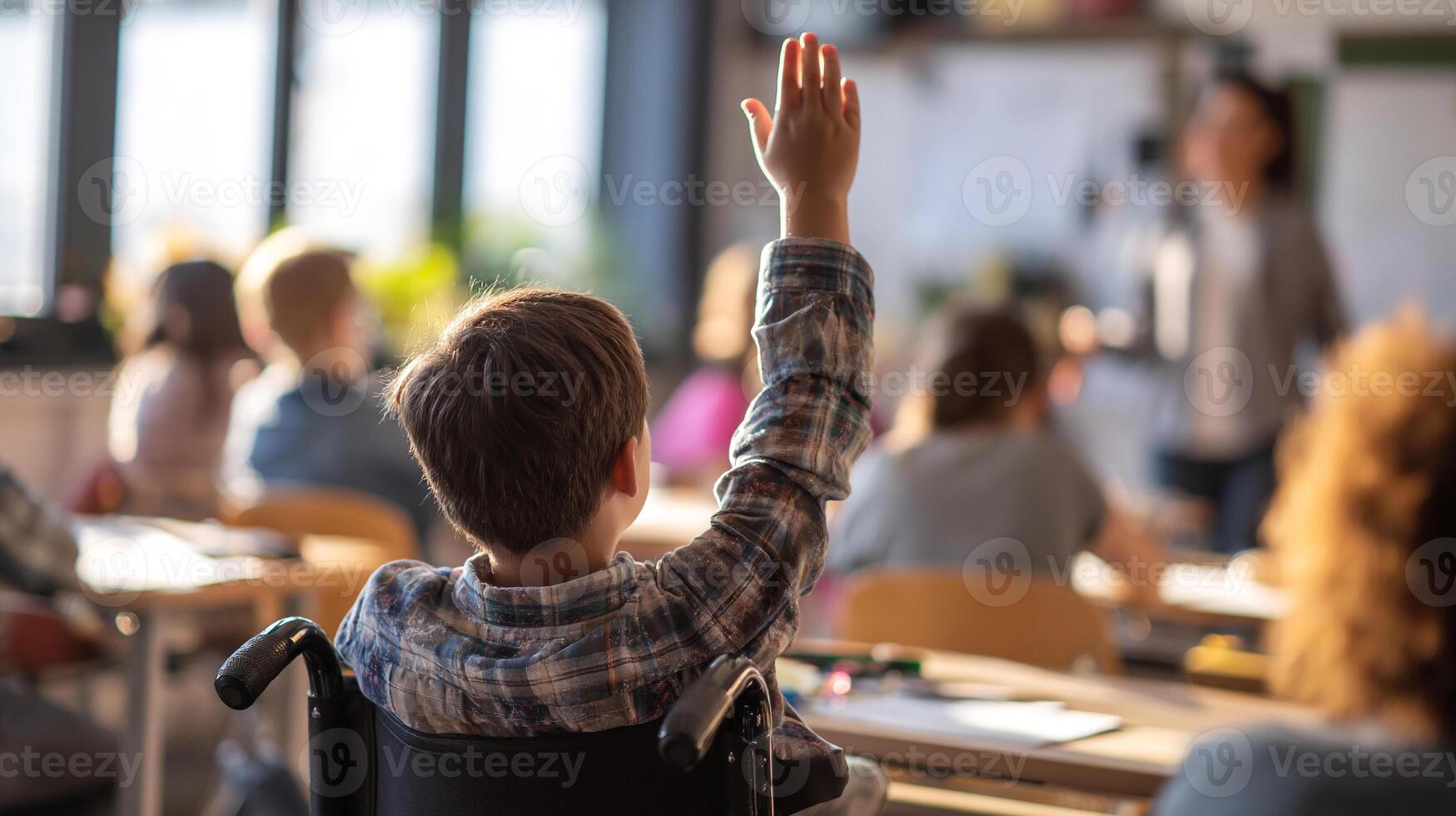 A child in a wheelchair raising his hand in class photo