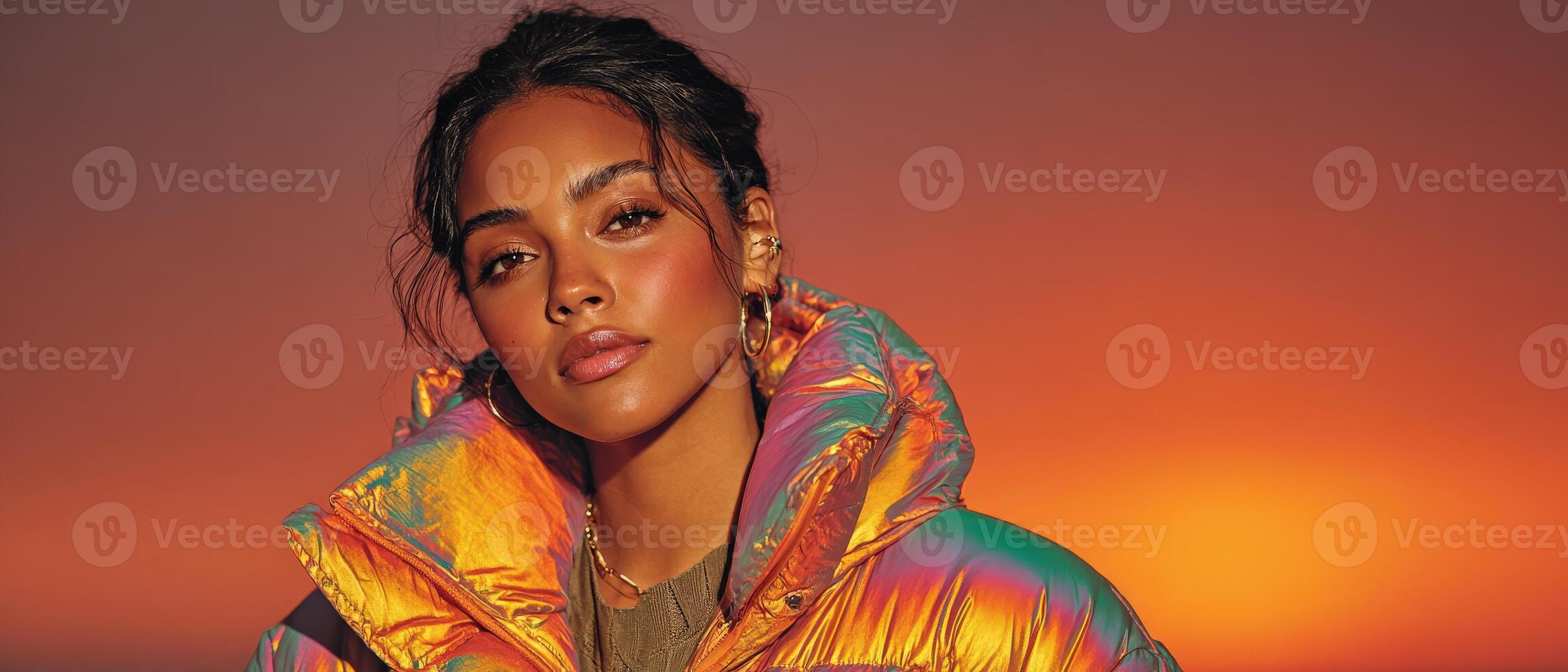 Portrait of a stylish young African American woman in iridescent puffer jacket against a warm sunset backdrop Concept of fashion, beauty, and modern lifestyle photo