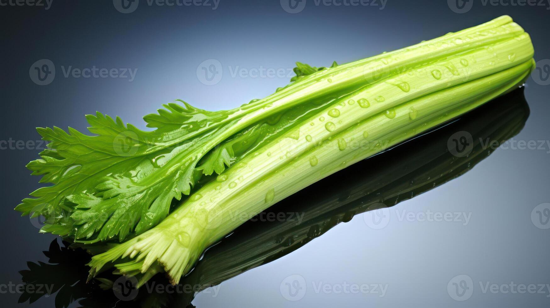 Crisp celery stalk with vibrant green leaves against a blue background. photo