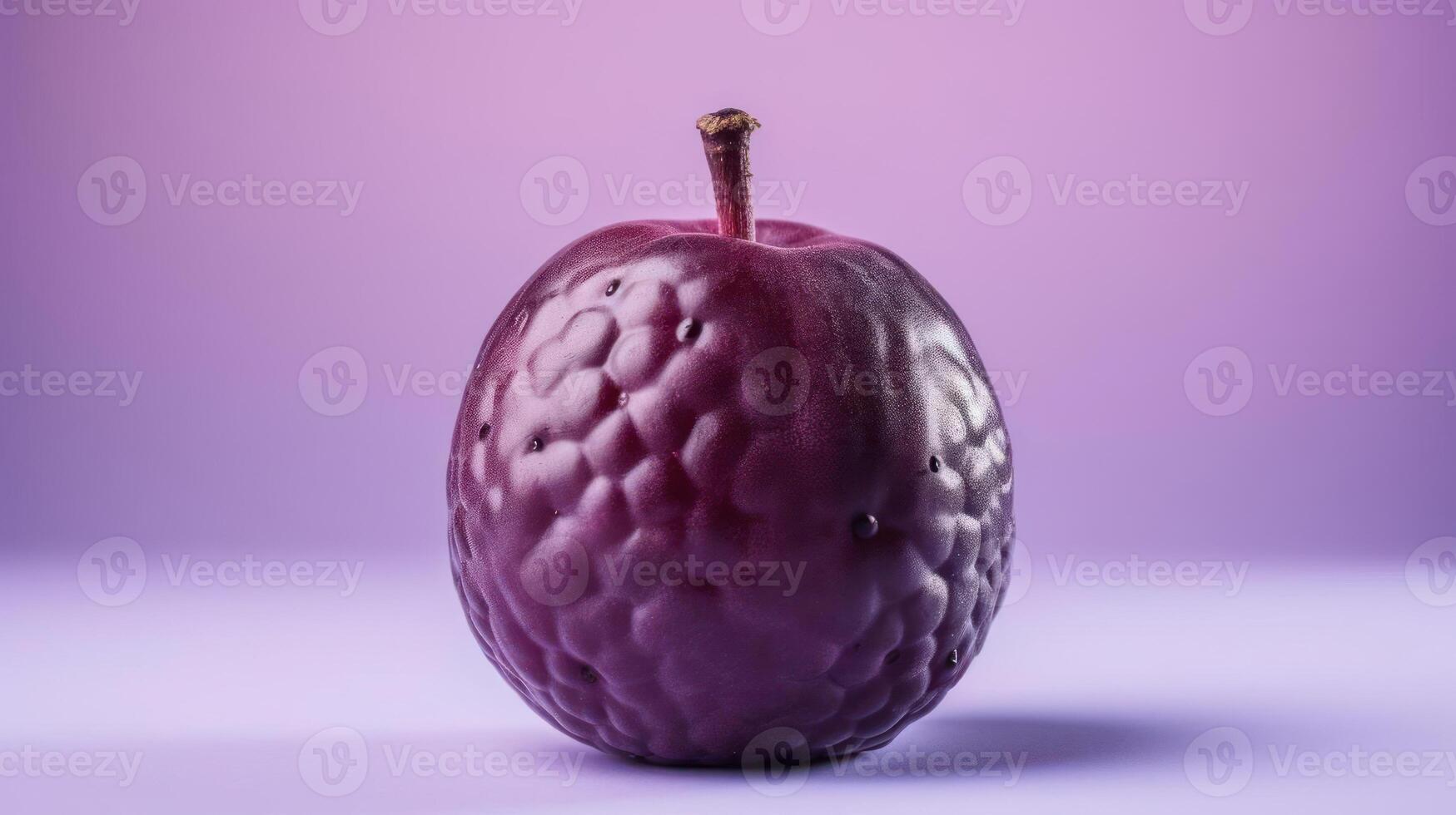 Close-up of a dark, textured plum against a purple background. photo