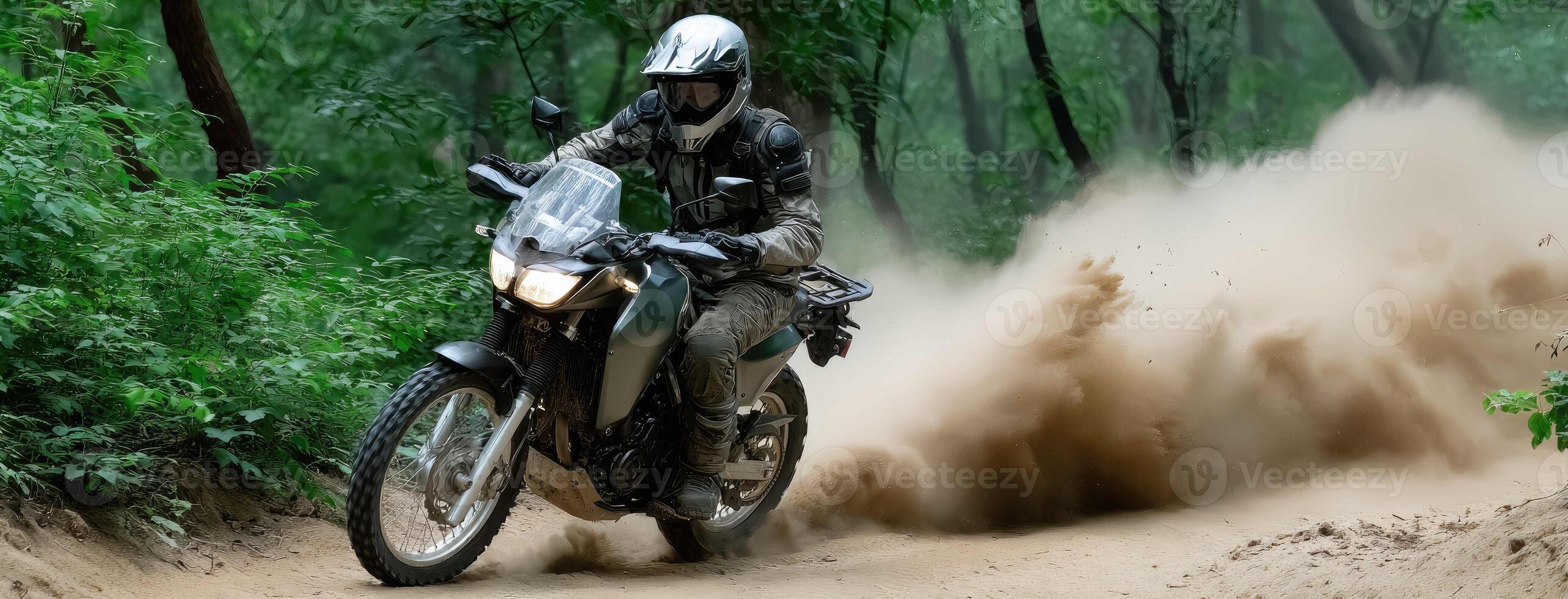 A person riding a motorcycle on a dirt road photo