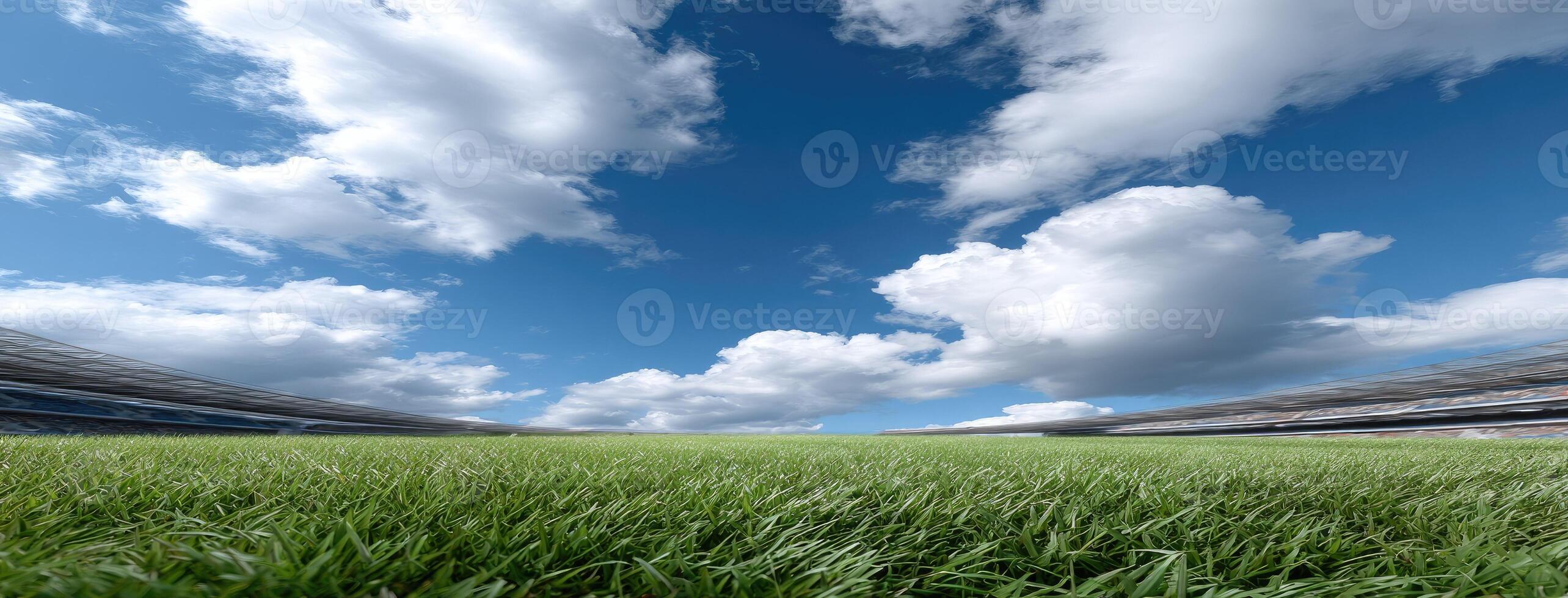 An empty soccer field with grass and clouds photo