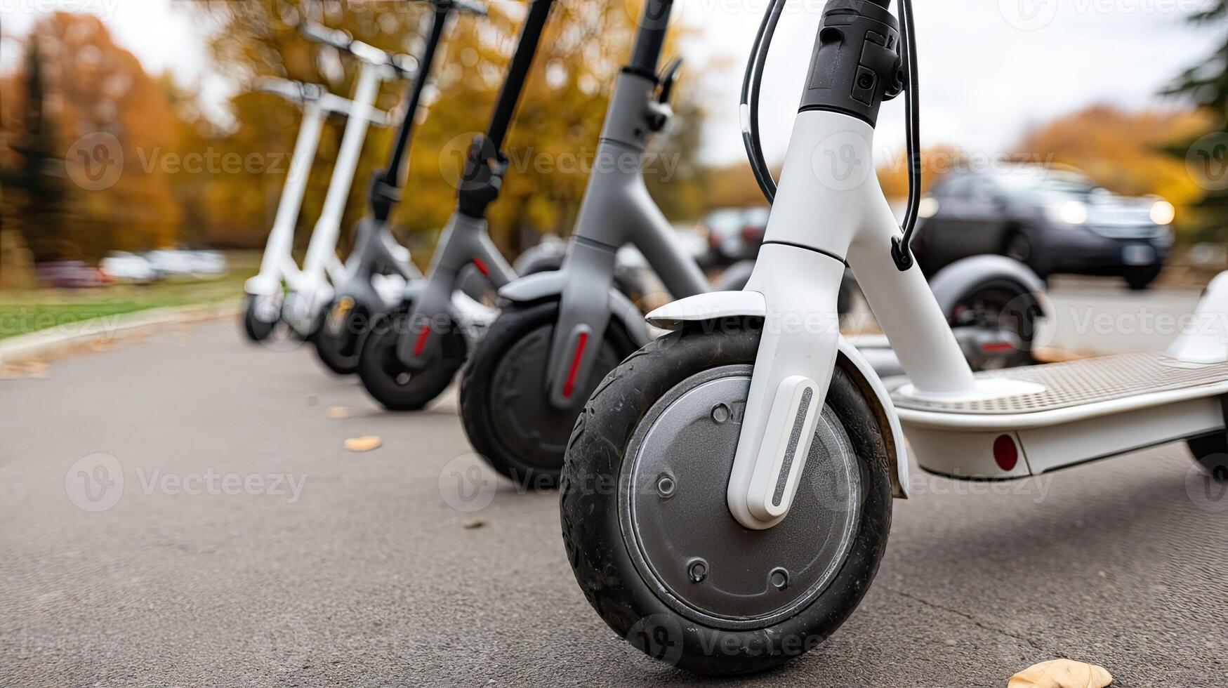 A row of electric scooters lined up on the street photo