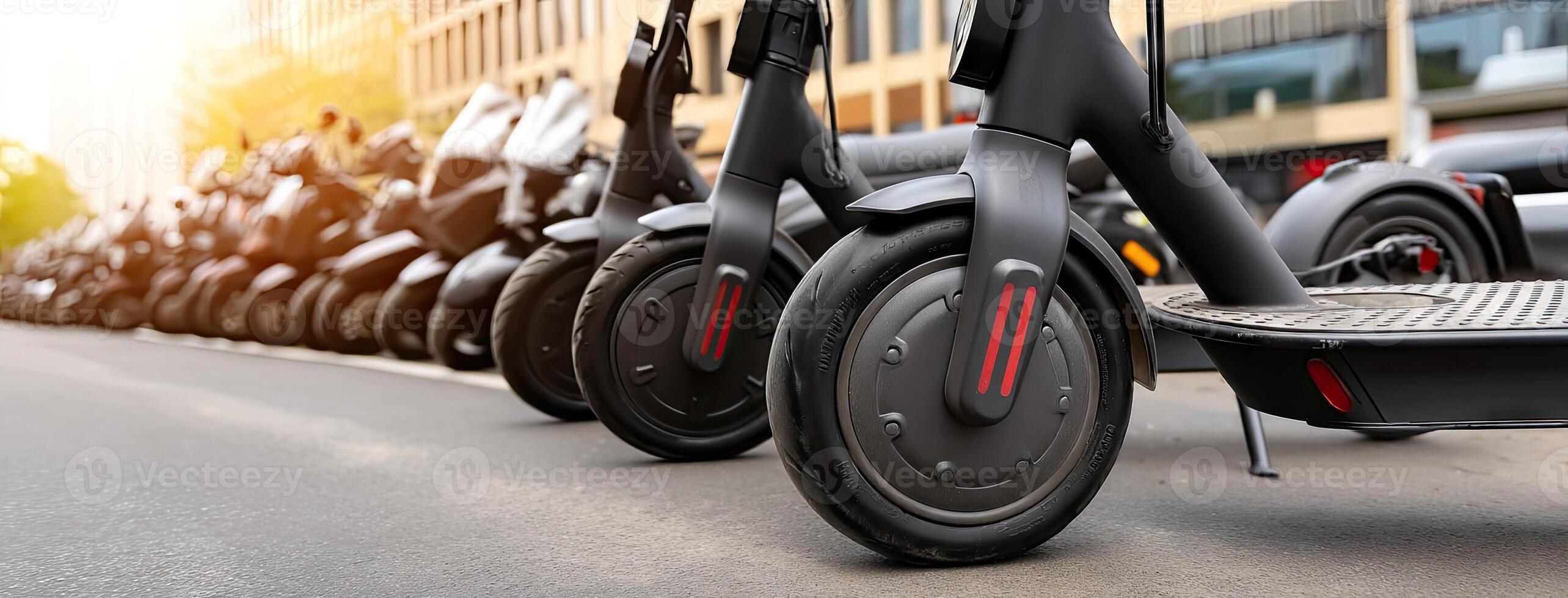 A row of electric scooters are parked on the street photo