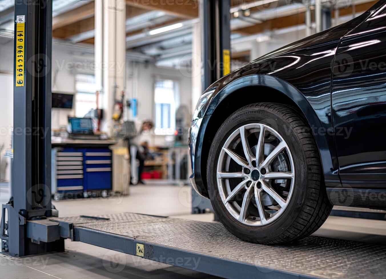 A car is being worked on in a garage photo
