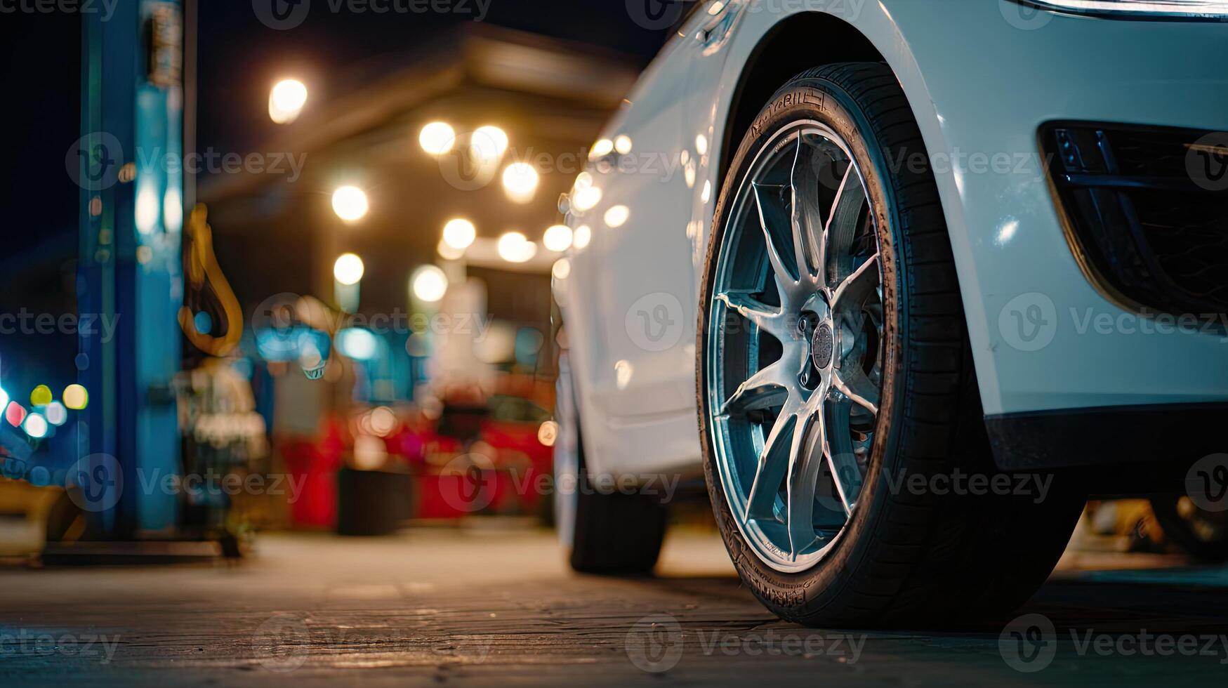 A white car is parked in front of a gas station photo