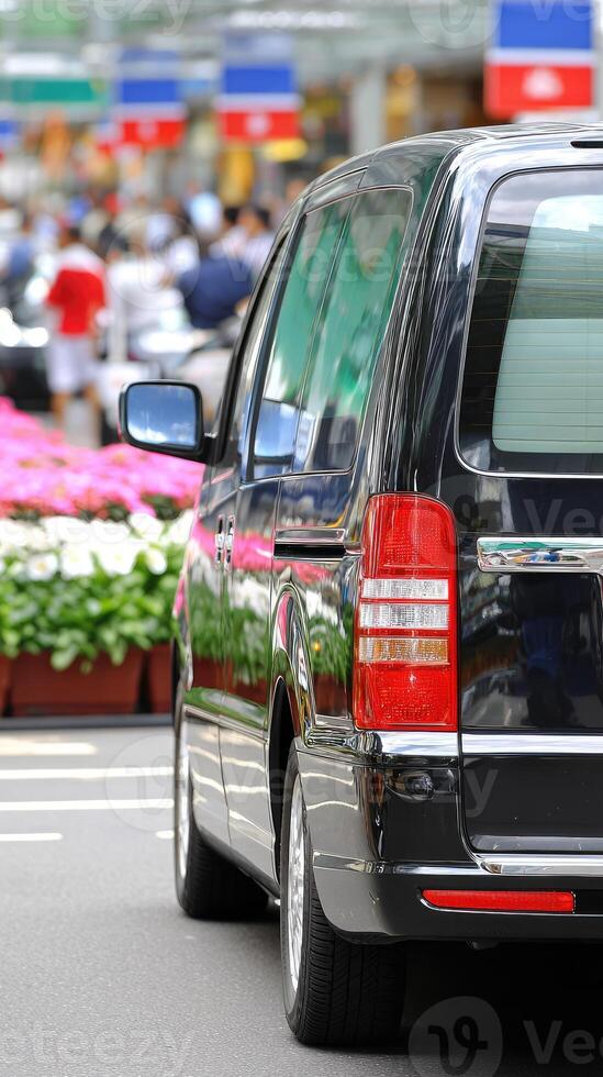 A black car is parked on the street photo