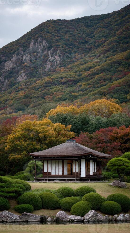 A small japanese house in the middle of a lush green field photo
