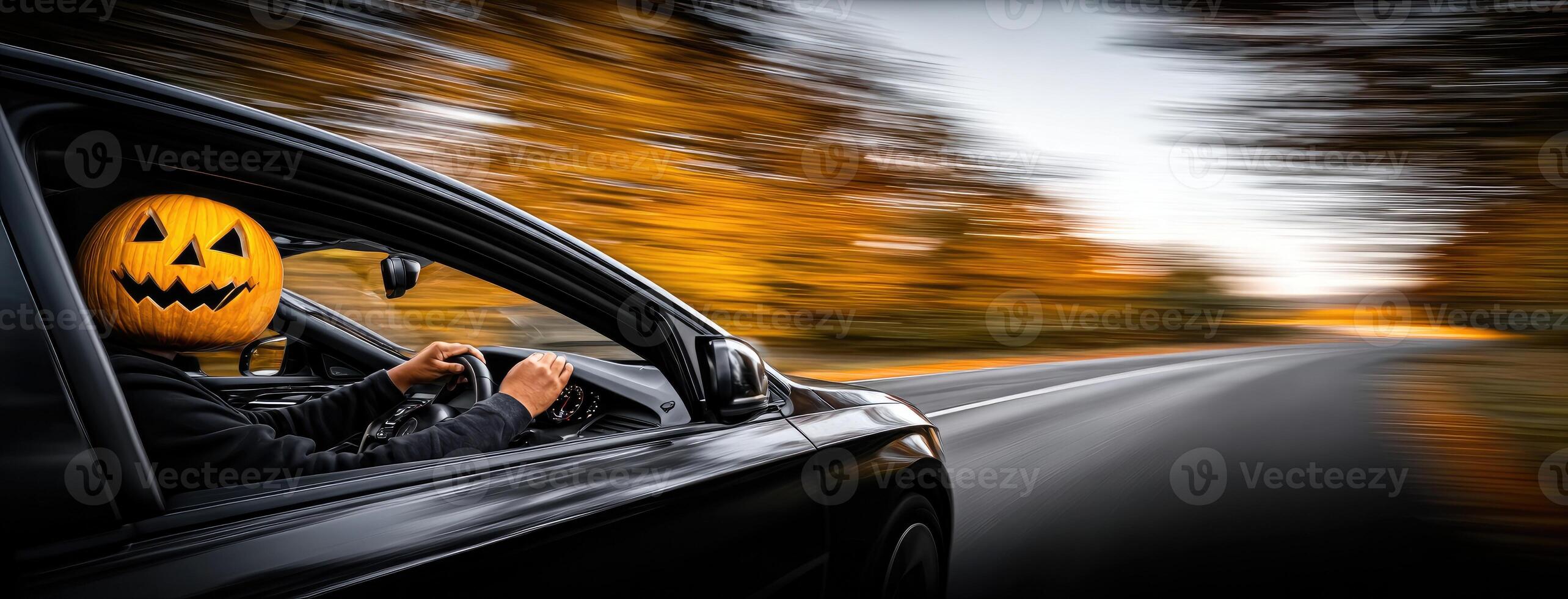A person driving a car with a pumpkin face on the dashboard photo