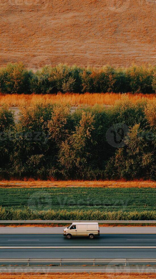 A van driving down a highway with trees in the background photo