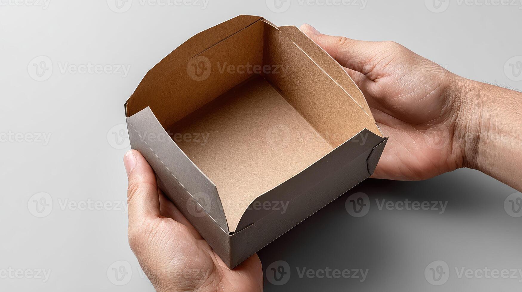 A person holding a cardboard box with a lid photo
