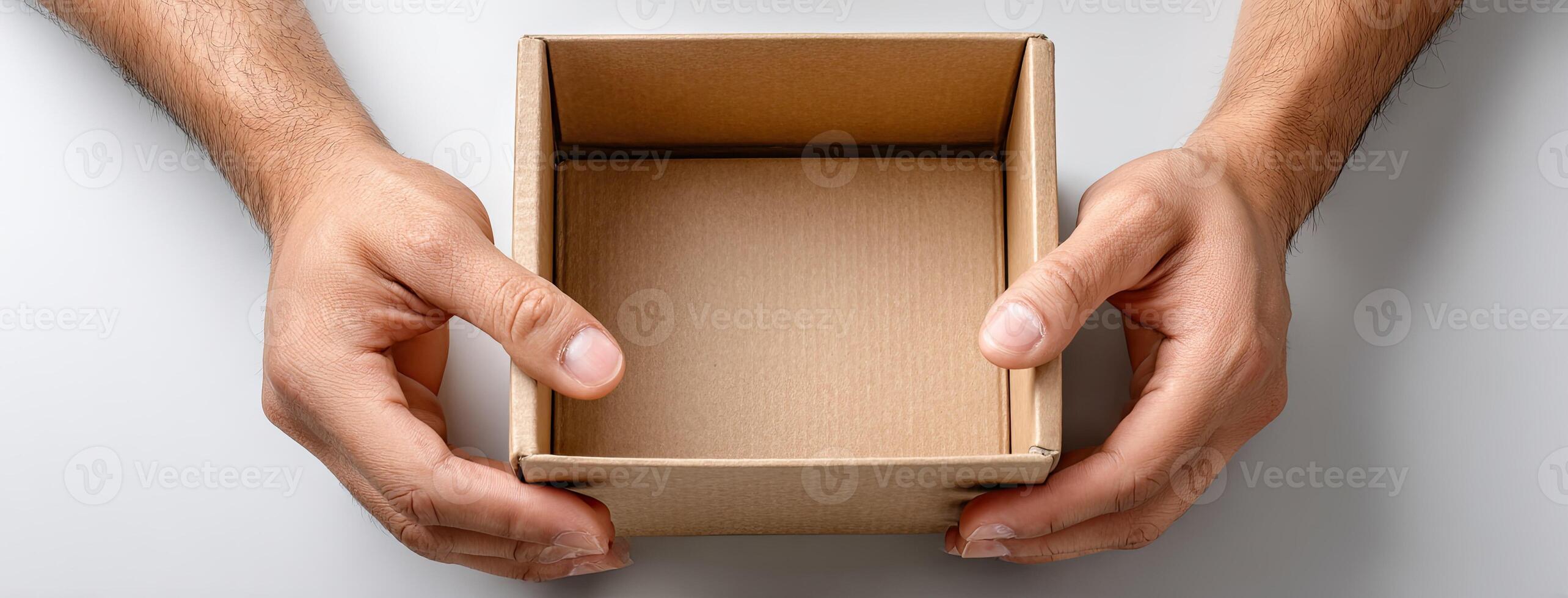 A person holding a cardboard box with a blank space photo
