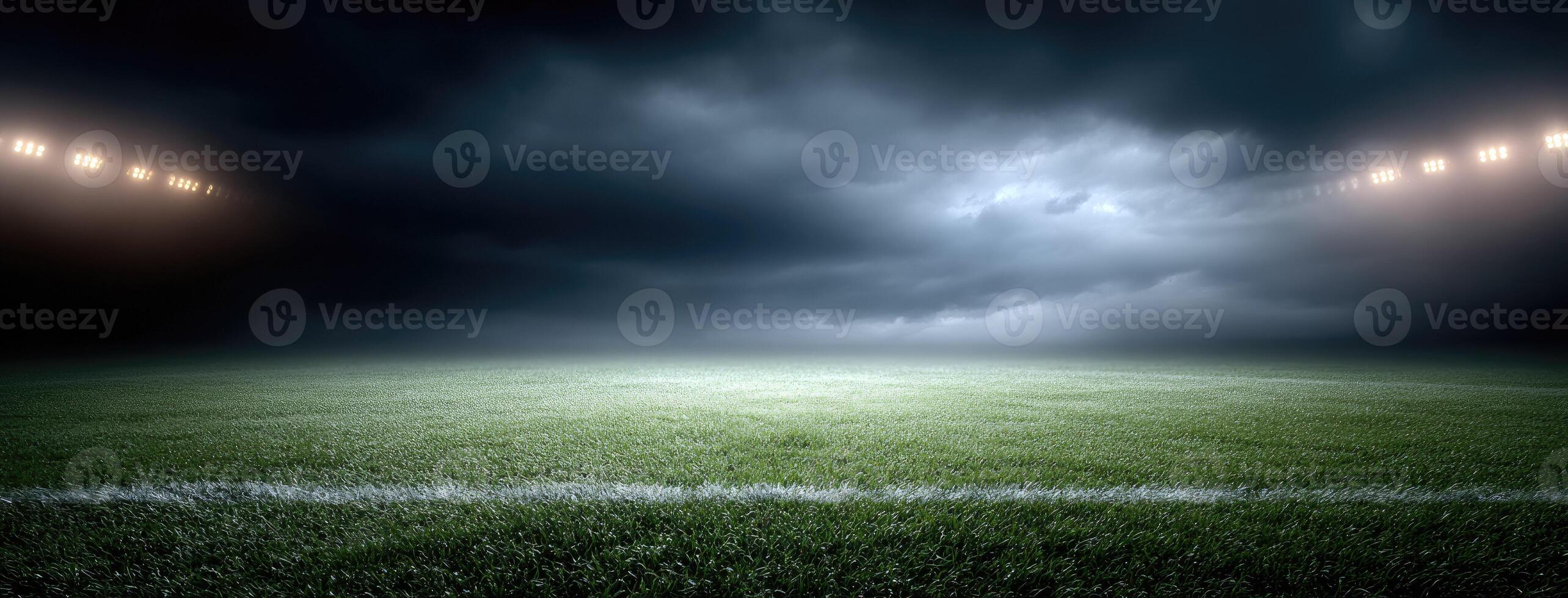 An empty soccer field with lights and a dark sky photo