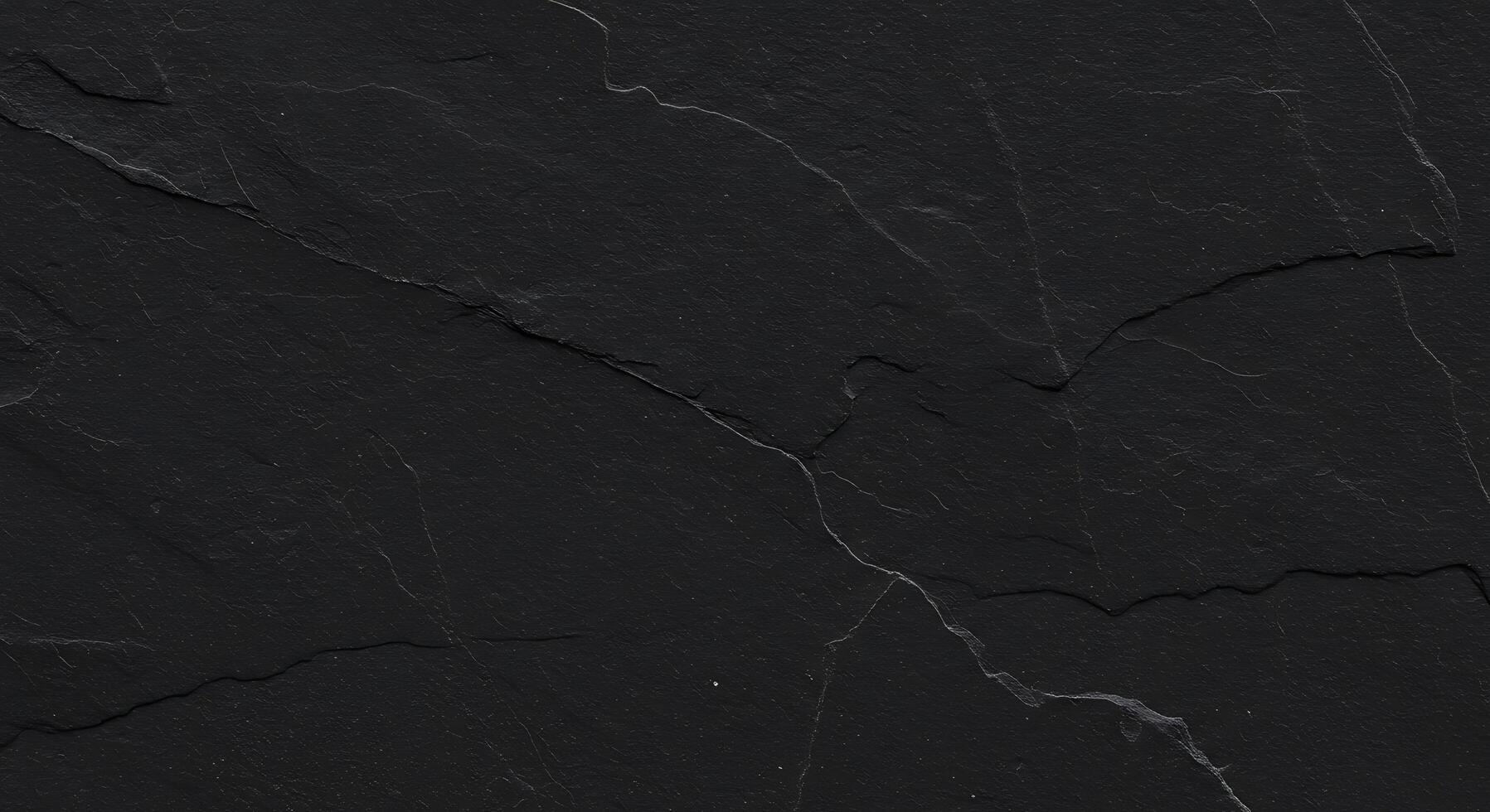 A black slate surface with cracks and cracks photo