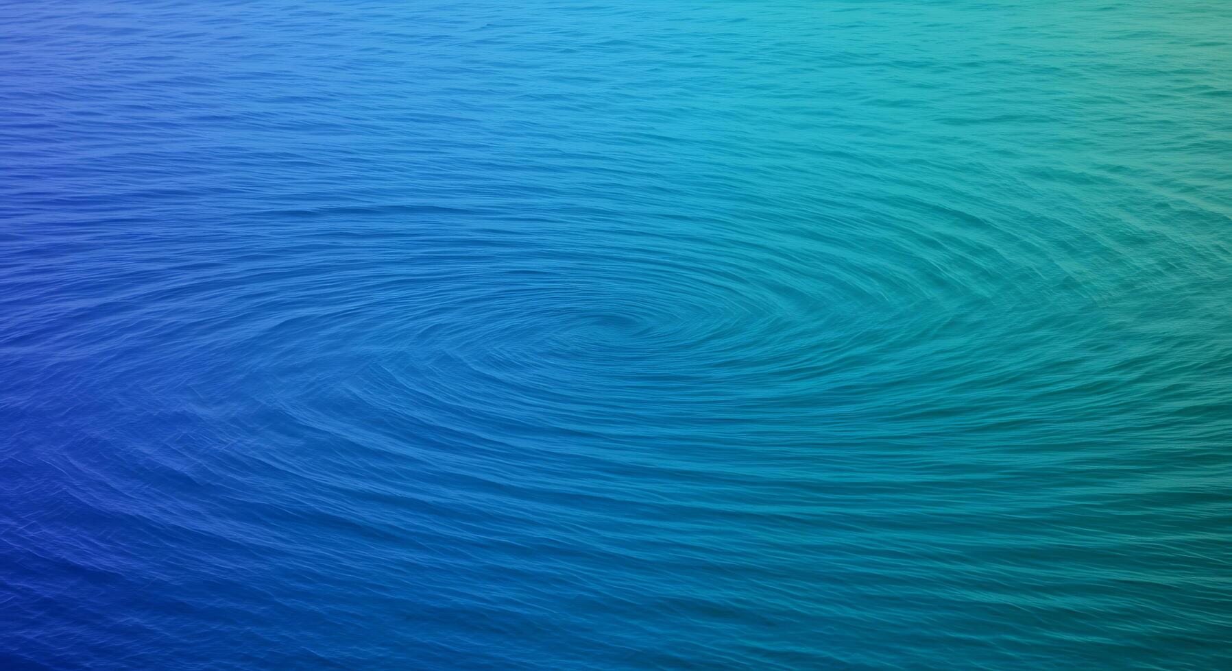 A blue and green water surface with a spiral pattern photo