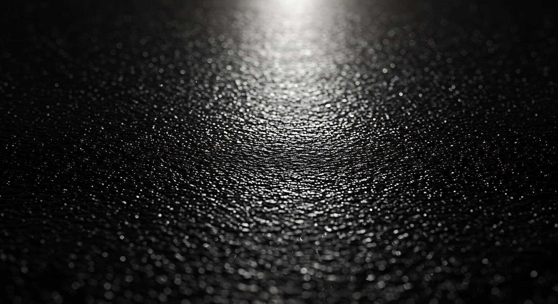 A black and white photo of a shiny surface