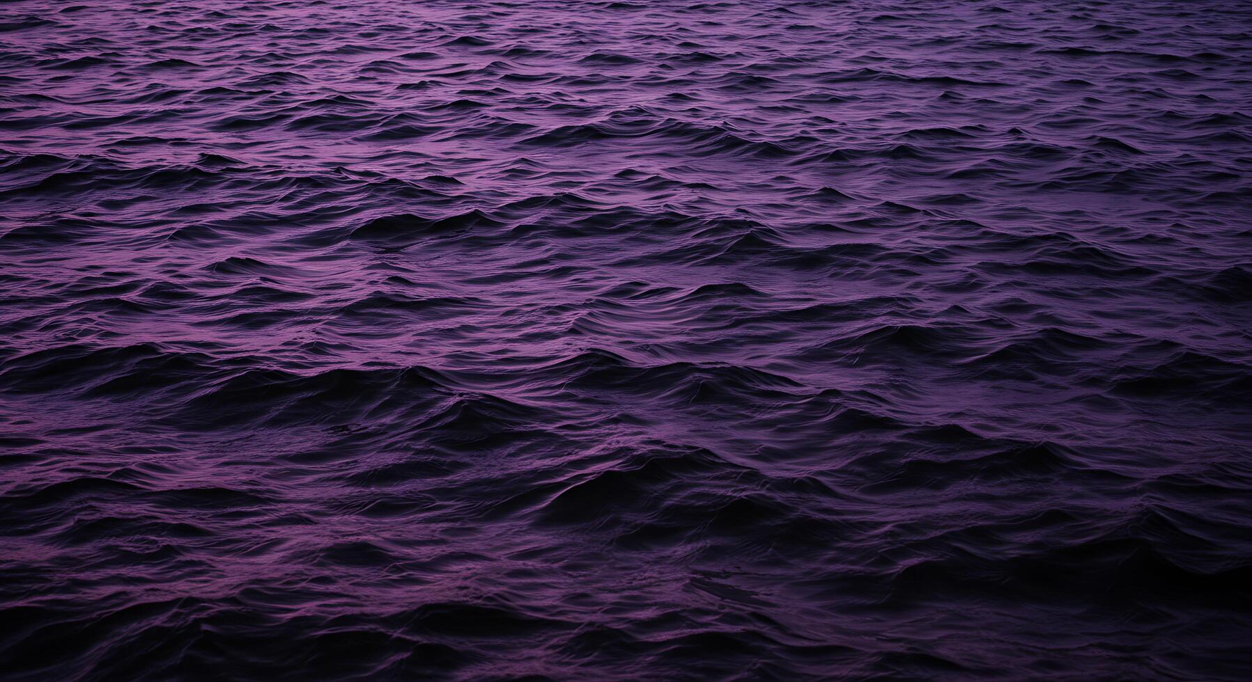 A purple ocean with waves and dark purple water photo
