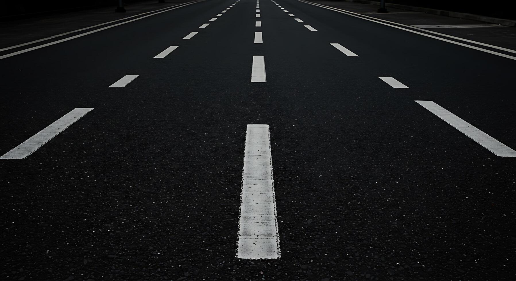 An empty road with white lines on it photo