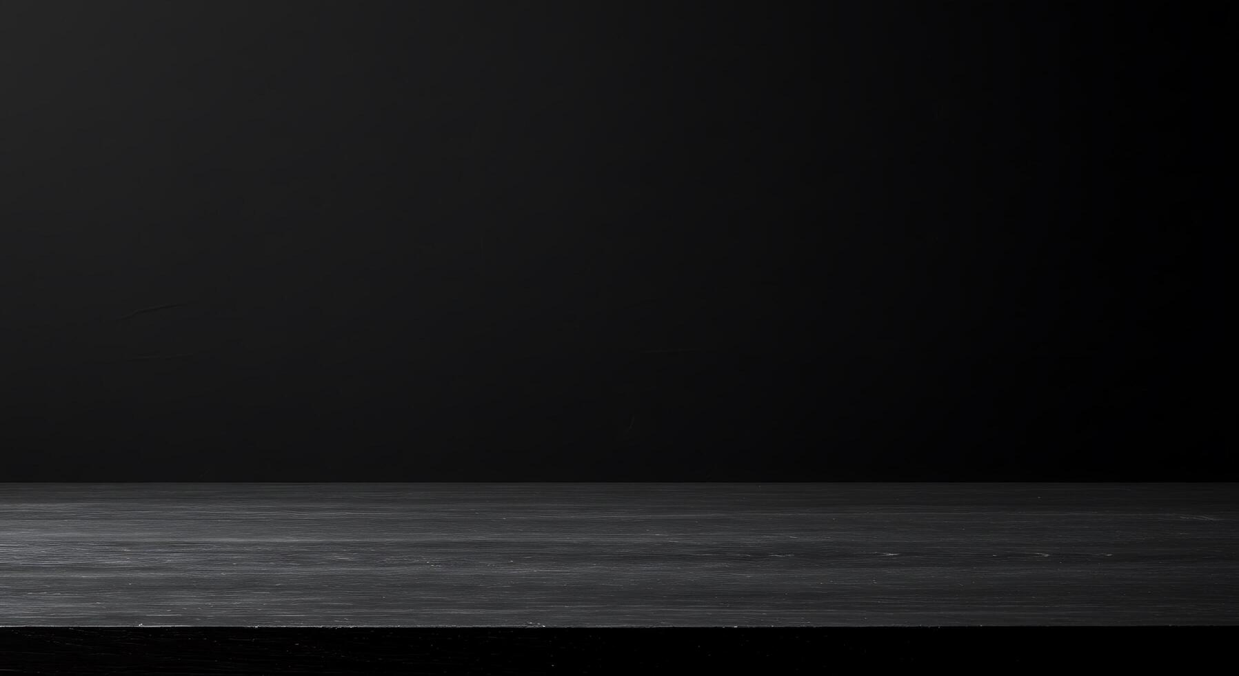 Black table top with empty glass bottle on top photo