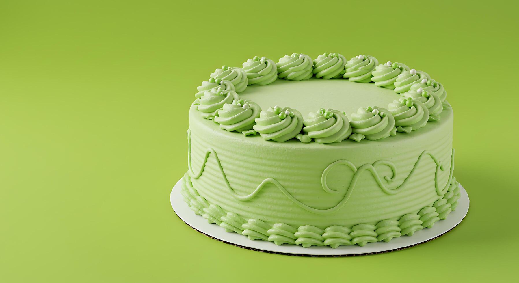 A green cake with a white frosting on top photo