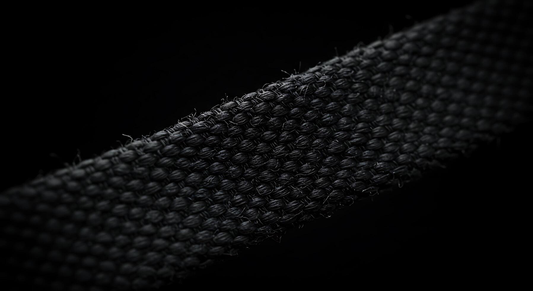 A close up of a black fabric with a small hole photo