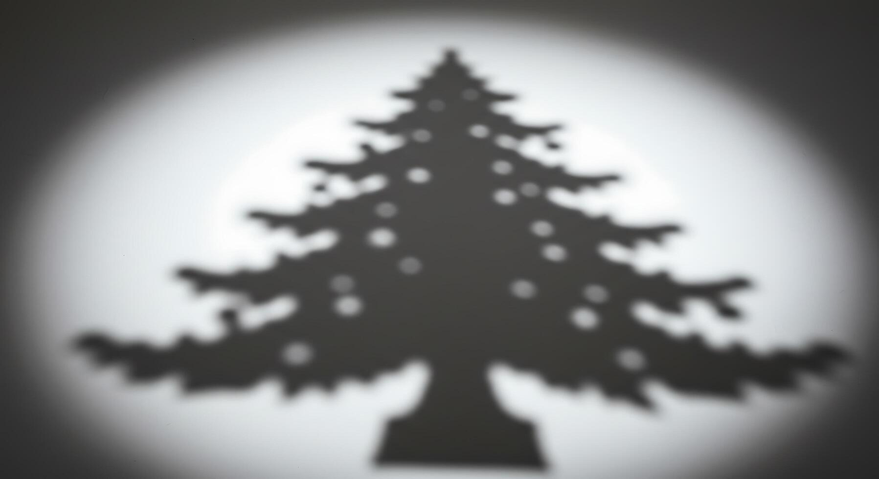A shadow of a christmas tree is shown in the light photo