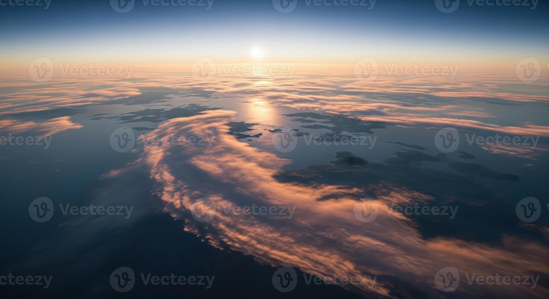 A view of the sun rising over clouds from an airplane photo