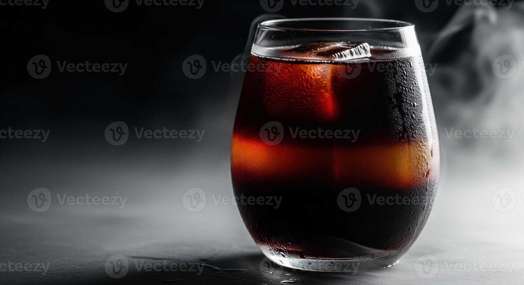 A glass of cola with smoke coming out of it photo
