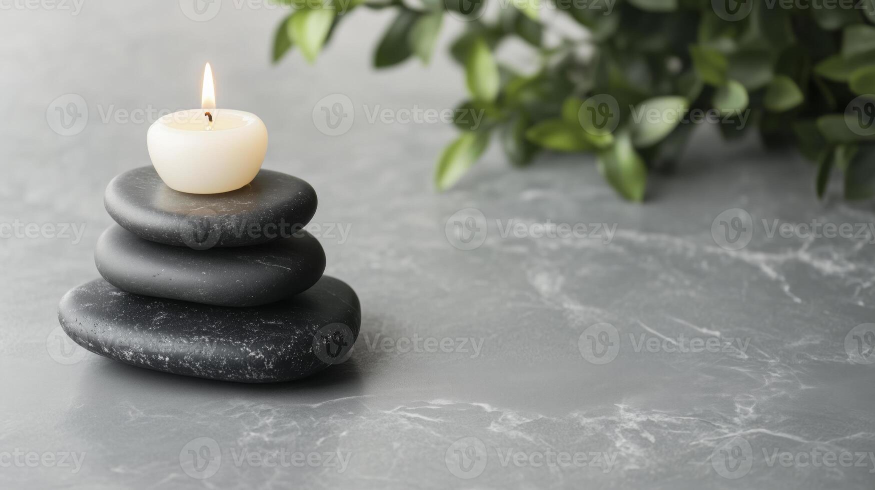 A candle is sitting on top of a stack of stones photo