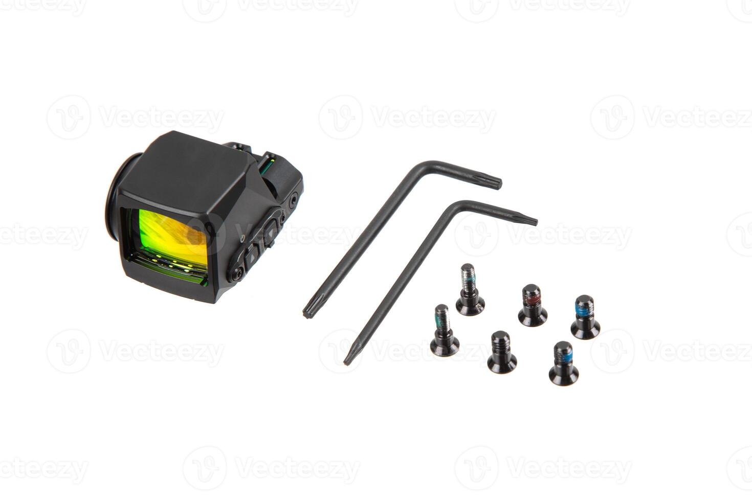 Compact reflex sight with mounting tools and screws on white back photo