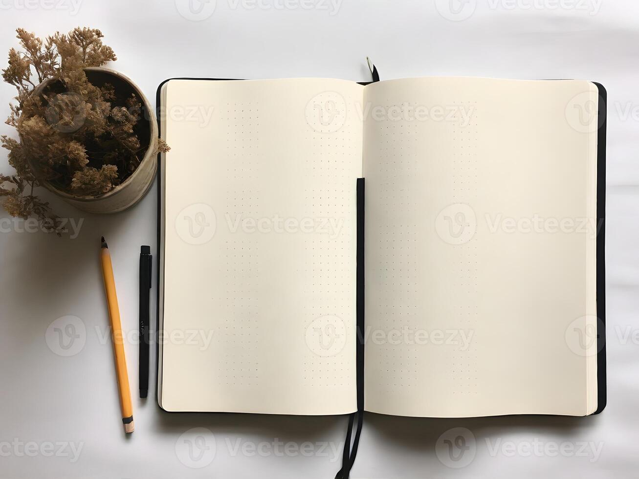 Blank Dot Grid Notebook with Dried Flowers and Pencils photo