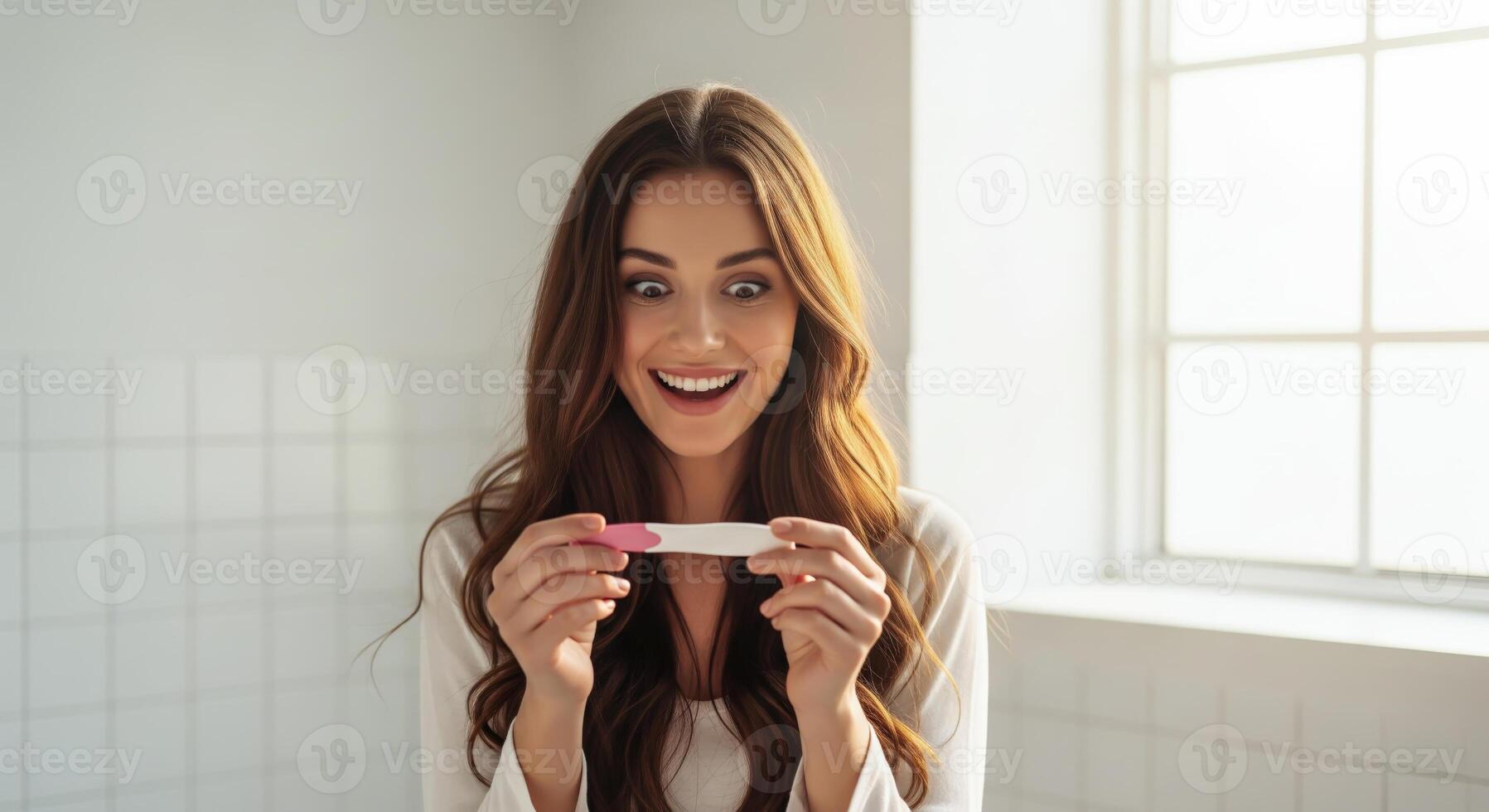 A pregnant woman holds a pregnancy test with a joyful expression. . photo