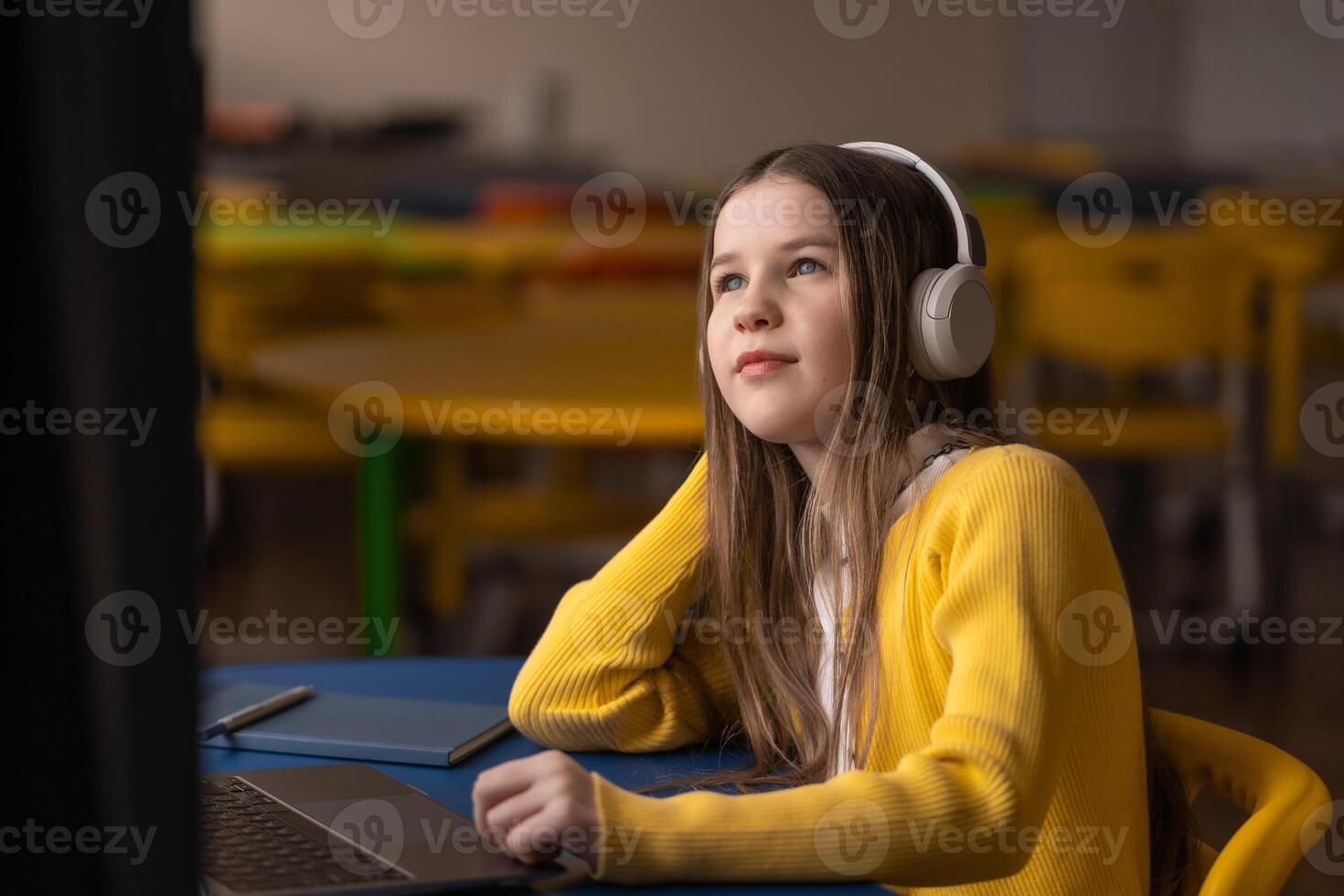 Girl in headphones explores future skills through calm audio learning in stress-free classroom photo