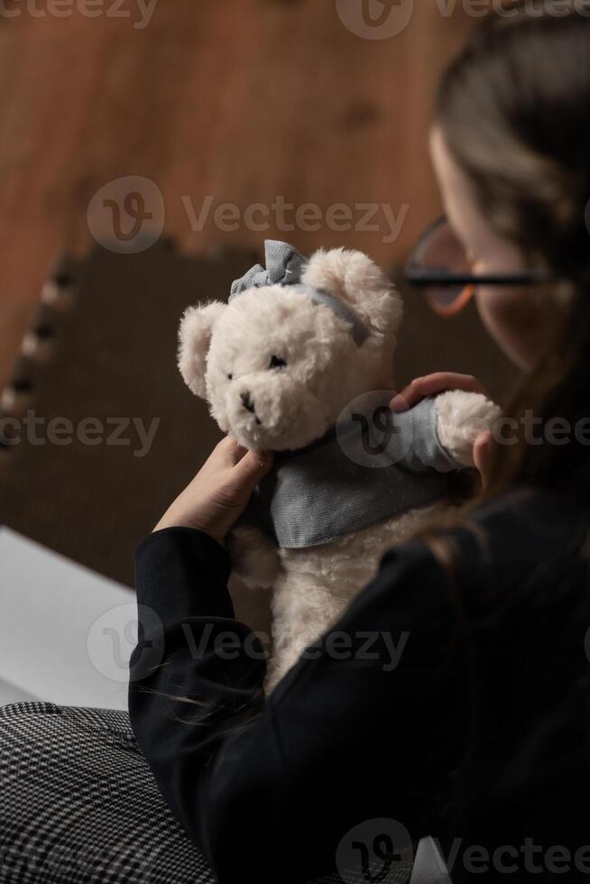 Child gently interacting with plush toy developing emotional intelligence and early empathy photo