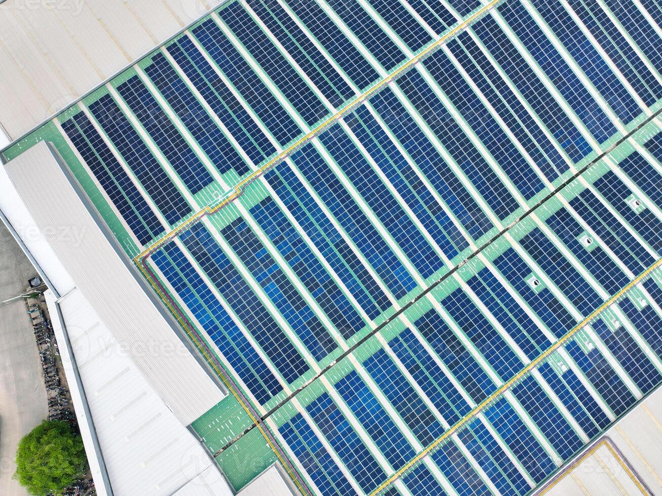 Solar panels on industrial factory rooftop. Renewable energy. Sustainable manufacturing. Green technology. Rooftop solar power. Commercial buildings with efficient renewable energy infrastructure. photo