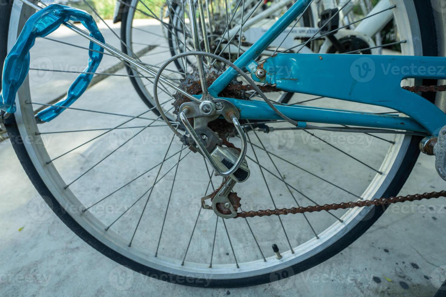 Close-up of bicycle wheel parked in bike rack at eco-friendly hotel. Sustainable transportation options for environmentally conscious guests during leisure travel. Sustainable mobility solution. photo