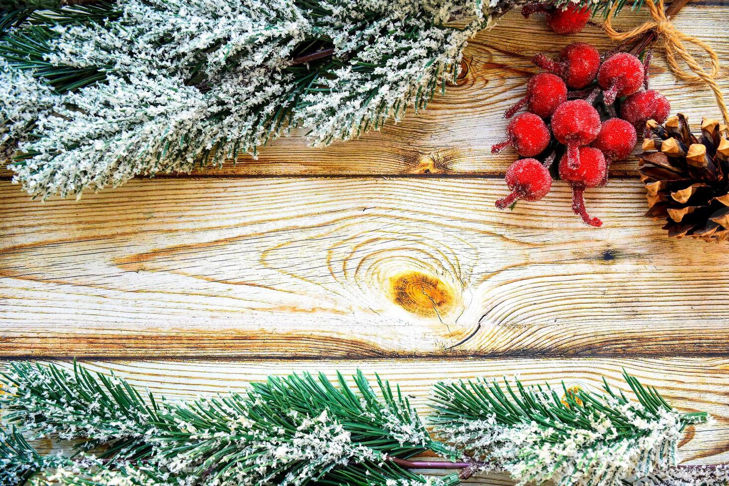 Wooden background frame with snowy fir tree branches, Christmas berries and fir cone. new year design, copy space photo