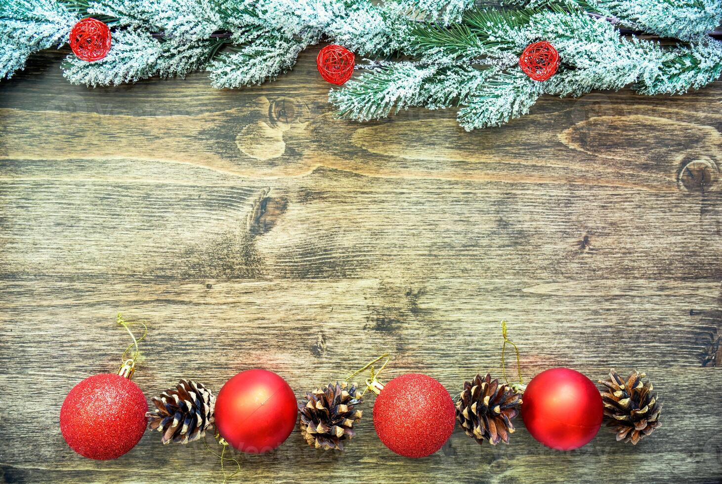 Wooden background frame with snowy fir tree branches, red Christmas tree toys and fir cones. new year design, copy space photo
