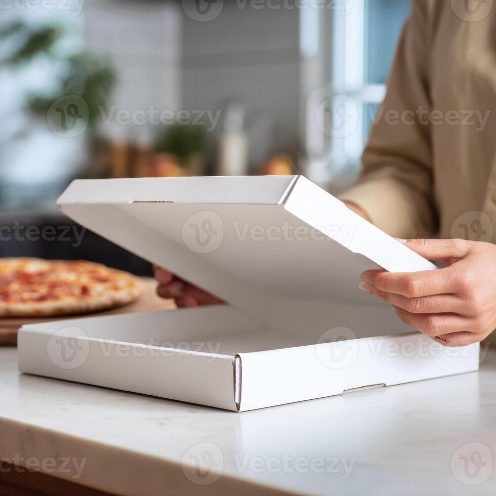 A woman is opening a pizza box photo
