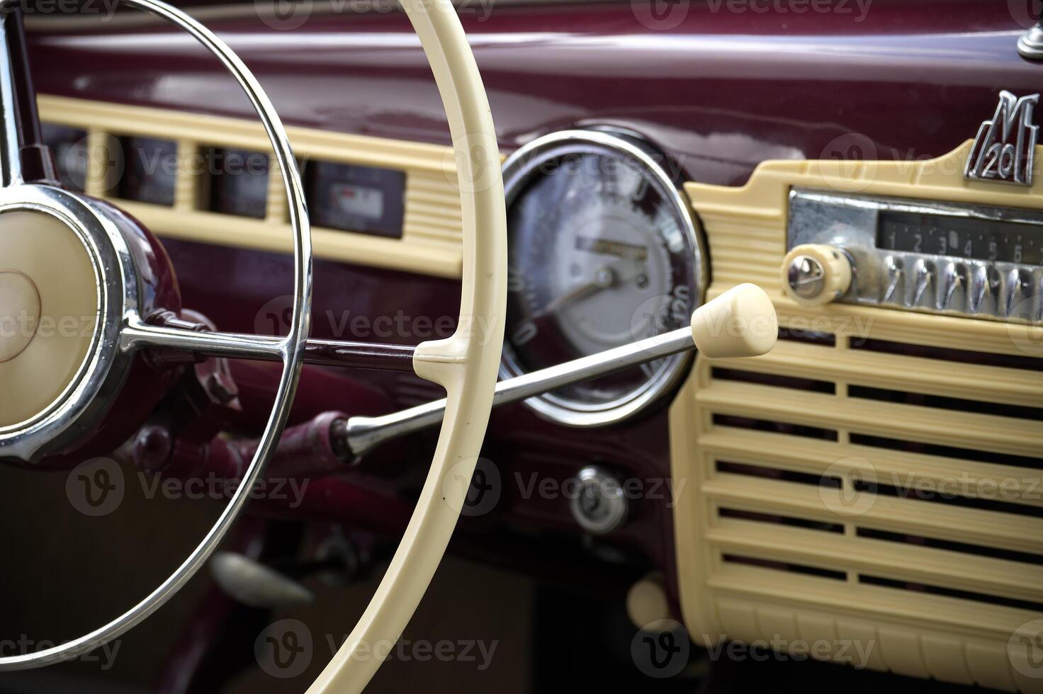 Vintage Car Dashboard Featuring Steering Wheel and Retro Radio Dials photo