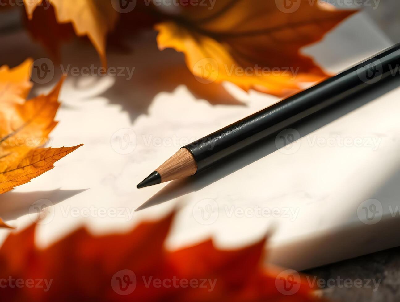 Autumn Inspiration Pencil on Marble with Vibrant Fall Leave Creative Writing Art and Design Concept photo