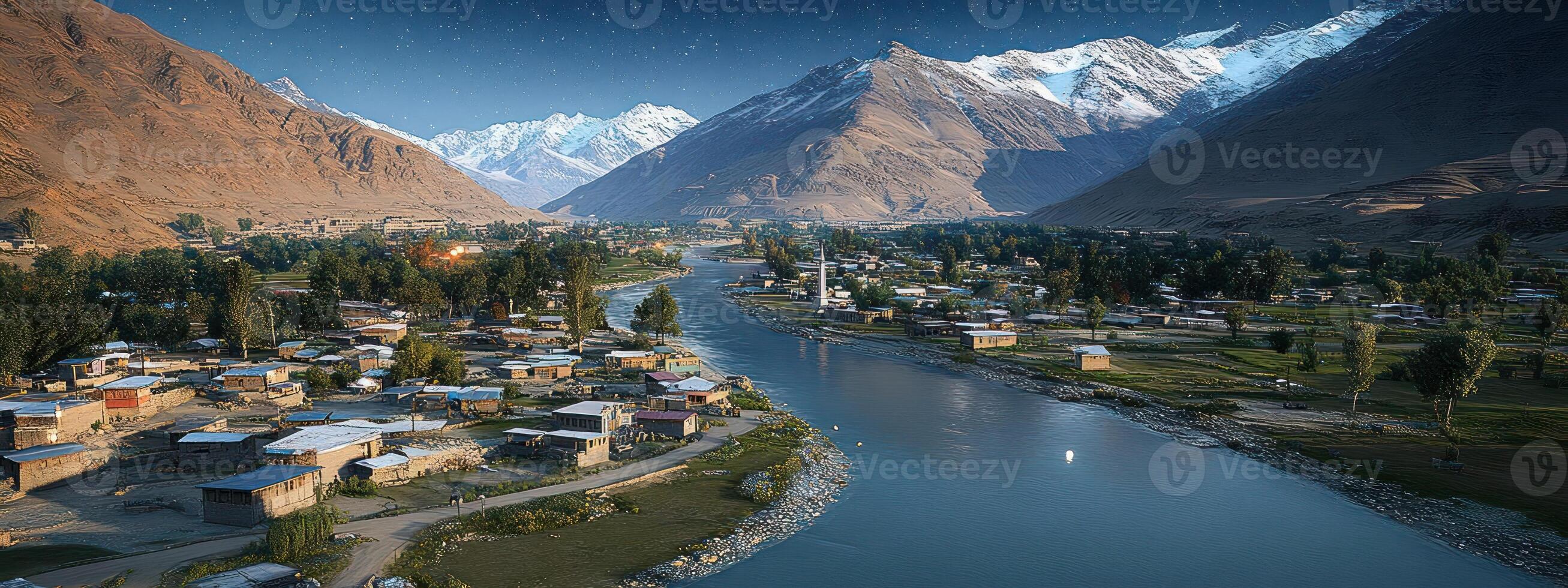 Mountain village nestled beside a river, bathed in warm light. photo