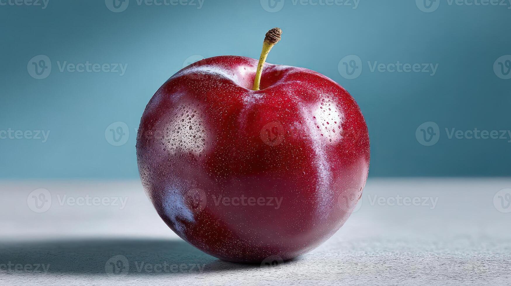 A single, ripe plum with a vibrant red hue. photo
