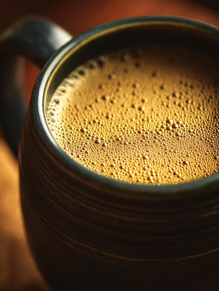Close Up of Golden Coffee Bubbles in a Dark Mug. A Detailed Macro Photograph of a Coffee Drink. photo