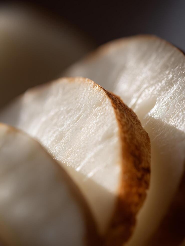 Close up of Sliced Raw Jicama, Showing Textural Details and Subtle Brown Edges. photo