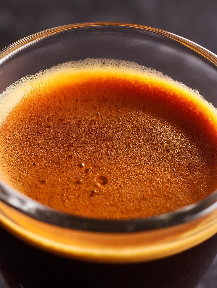 Close up of Espresso Crema in a Glass. A Detailed Image Showing the Rich Texture and Color of Freshly Brewed Espresso. photo