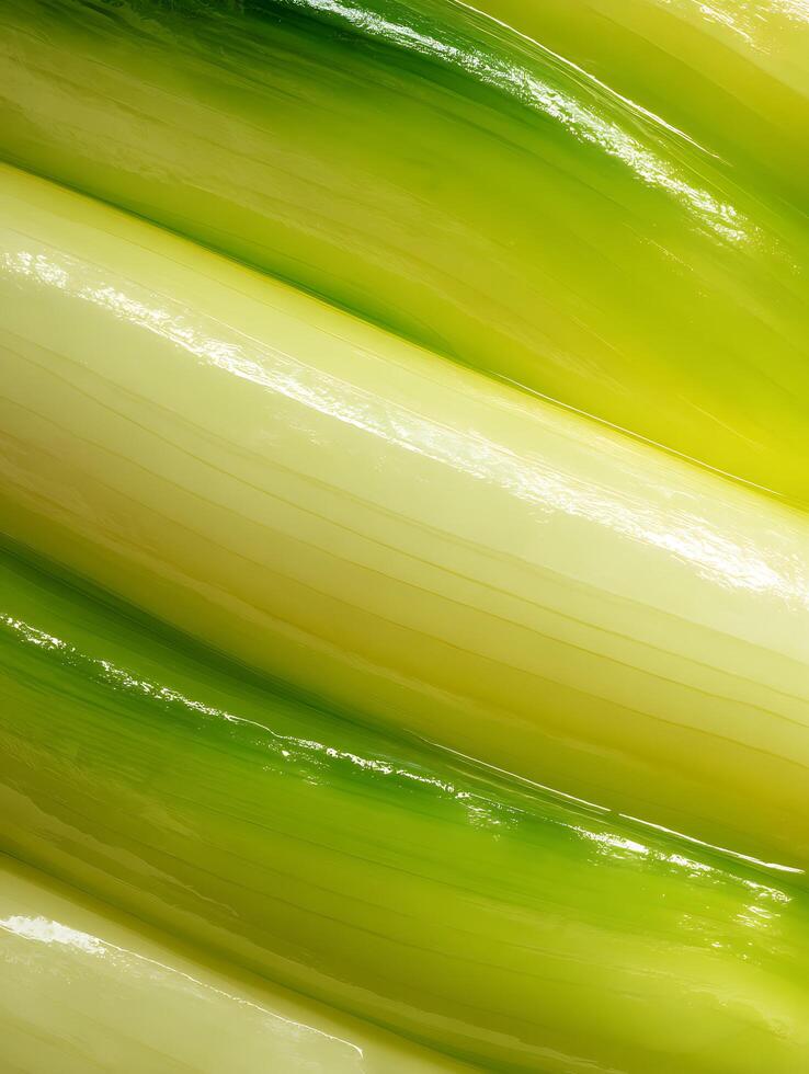 Close up of vibrant green and yellow leeks, showcasing their smooth texture and natural curves. photo