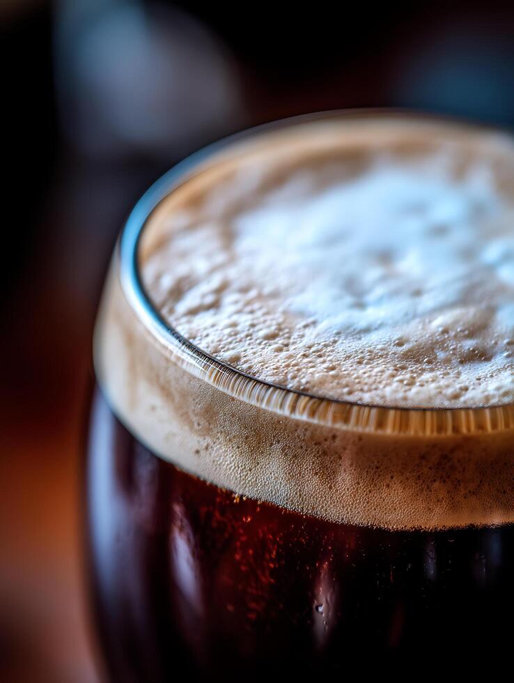 Close up of a glass of dark beer with a creamy head. A detailed image perfect for showcasing craft beer or beverages. photo